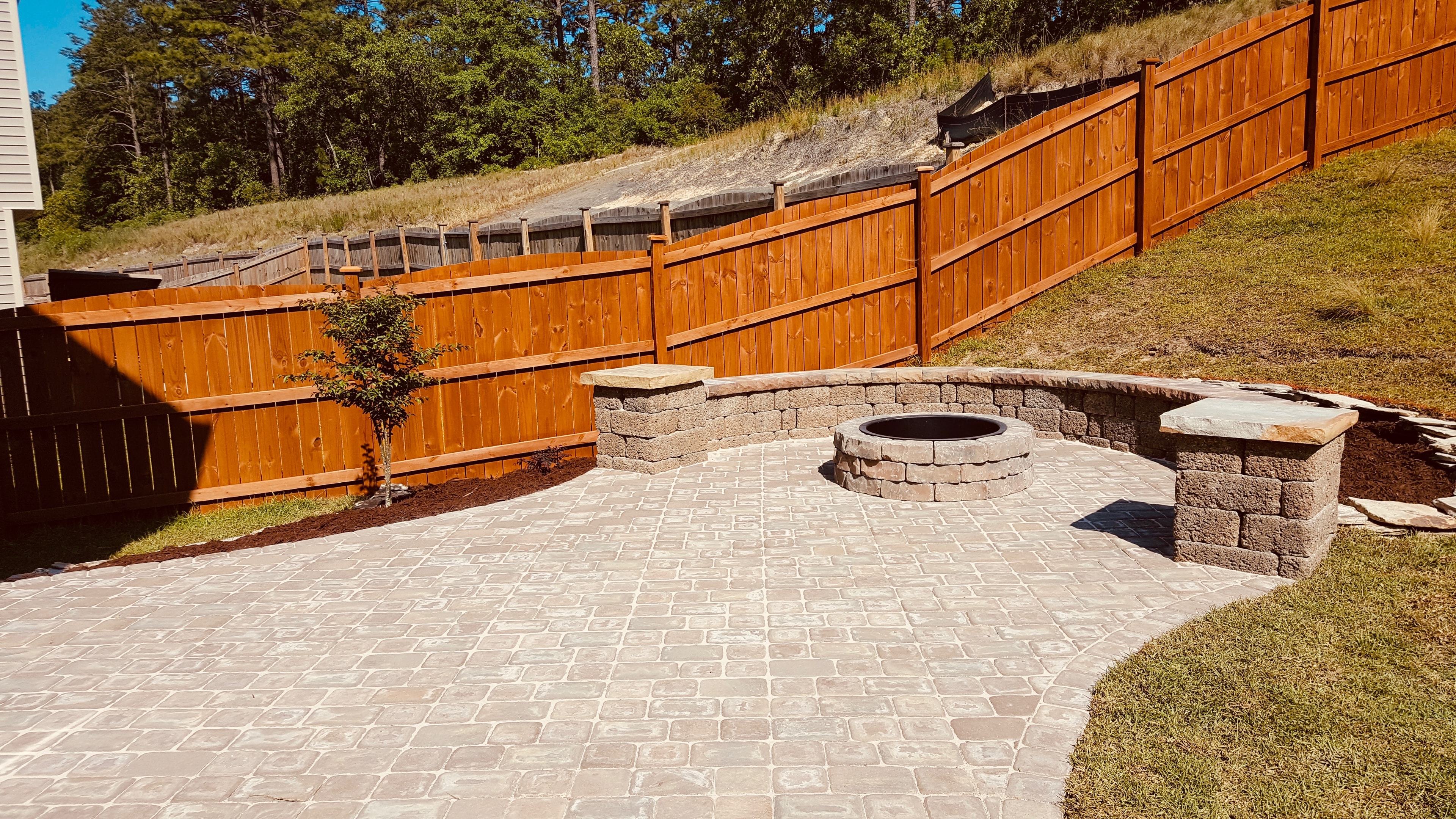 Backyard patio with fire pit seating area
