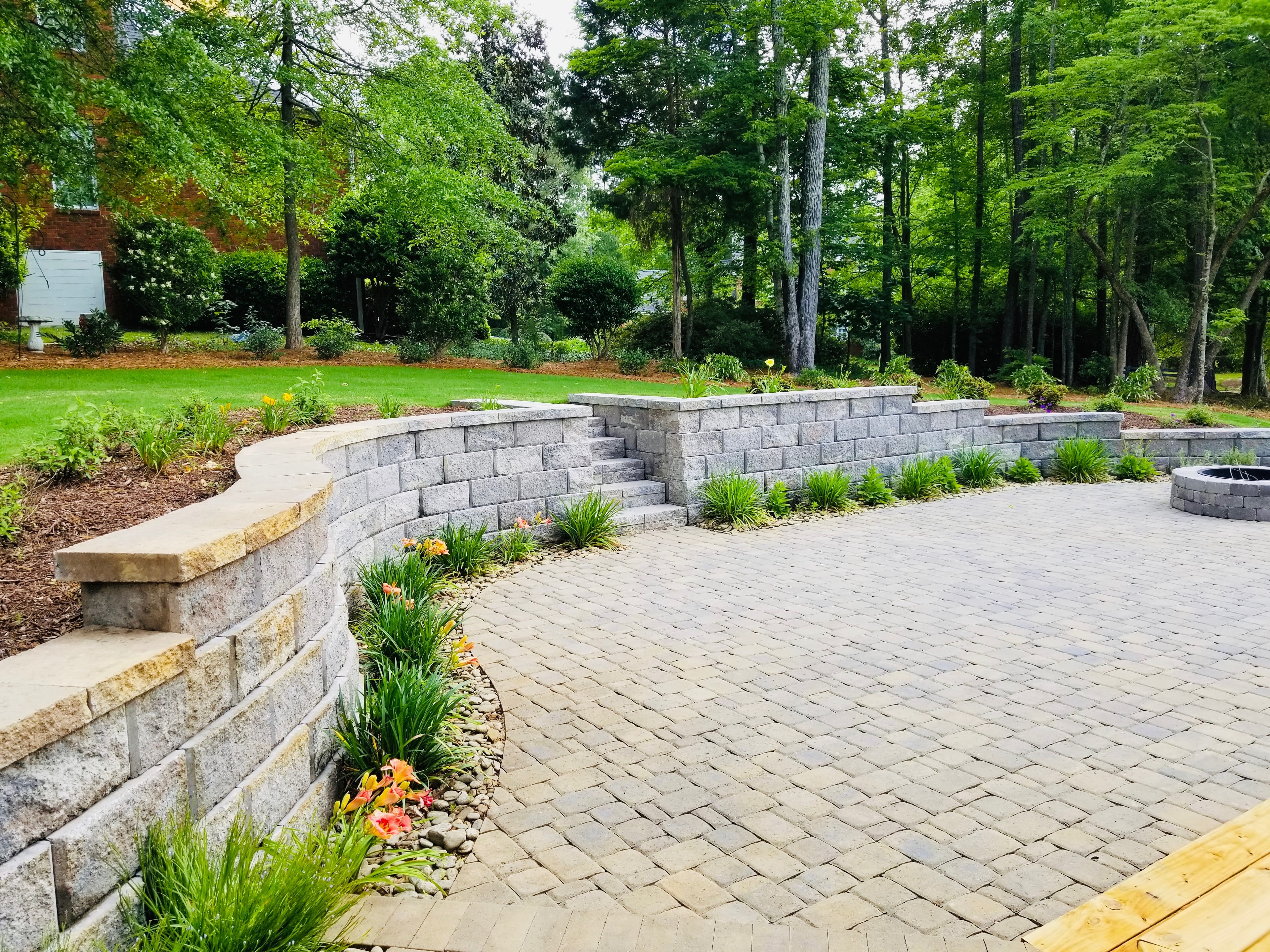 Paved patio with stone retaining walls